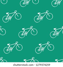 Seamless pattern with bicycle hand drawings on green background.  Vector illustration.