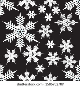 Seamless pattern of big and little white  snowflakes on a black background. Vector. Gift Christmas paper, christmas textiles. Christmas design and decoration.