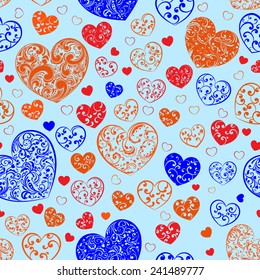 Seamless pattern of big and small hearts with curls, multicolored on light blue