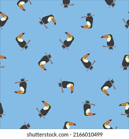 patrón transparente con aves. pequeños tocanes sobre un fondo azul claro. Impresión de moda para textiles, papel pintado y embalaje.