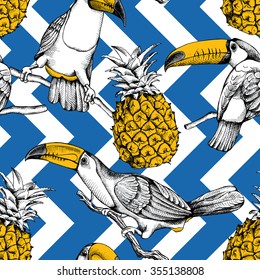 Seamless pattern with birds toucans on the branches and pineapples on blue geometric ornaments. Vector illustration.