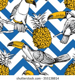 Seamless pattern with birds toucans on the branches and pineapples on blue geometric ornaments. Vector illustration.