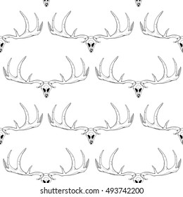 Seamless pattern. Black antlers and skull on a white background. Vector illustration.