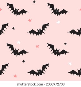 Seamless pattern with black bats on pink background. Halloween design for fabric and paper, surface textures. Pastel colors design.