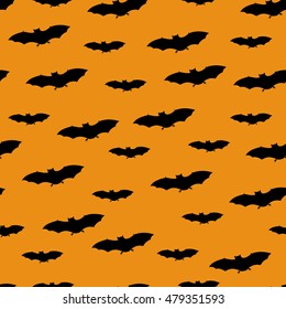 Seamless pattern with black bats on pumpkin orange color background. Halloween design concept. Can be used for scrapbook digital paper, textile print, page fill. Vector illustration