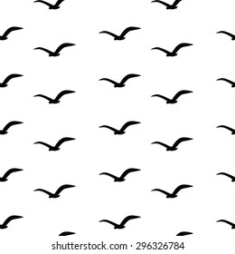 Seamless pattern with black birds on a white background. Seagulls are flying