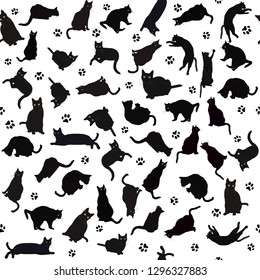Seamless pattern with black cats silhouettes and paws