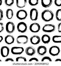 Seamless pattern with black circles on white background. Hand drawn polka dot vector ornament. Modern abstract design for print or textile. Different grunge rounded spots, circles and ovals.