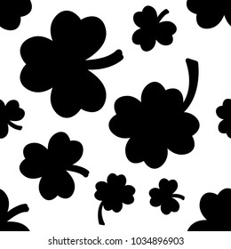 Seamless pattern with black clovers on white background. Vector illustration