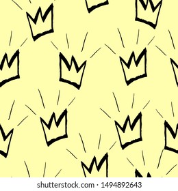 Seamless pattern with black crowns on a yellow background. Vector graphics.