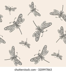Seamless pattern with black dragonflies on beige background.