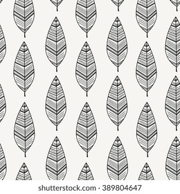 Seamless pattern with black feathers on white background.
