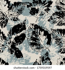 Seamless pattern of black and gray prints of leaves. Print for fabric, paper, wallpaper, cover. Vector illustration on a light background.