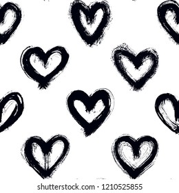 Seamless pattern with black hand-drawn uneven hearts isolated on white background. Ink doodle style abstract grunge texture.