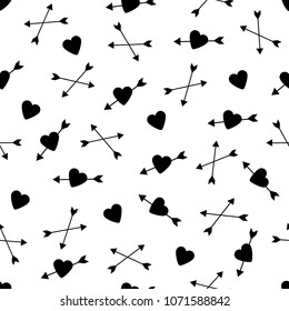 Seamless pattern with the black hearts and arrows. Vector illustration