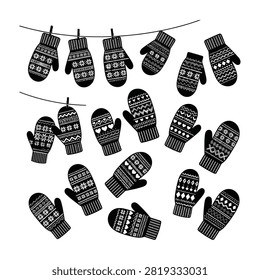 seamless pattern of black knitted winter mittens hanging on clothesline isolated on white background. textile design for winter wear.