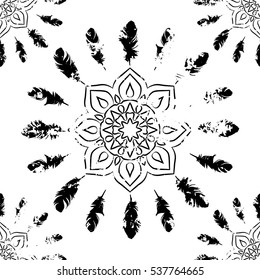 Seamless pattern with black mandalas and feathers on white. Ethnic American Indian pattern. Vector background.