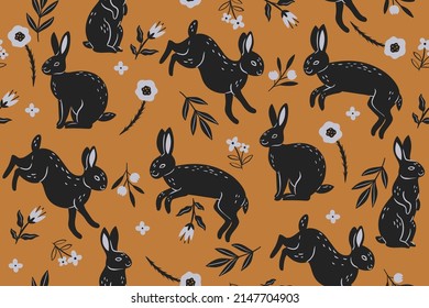 Seamless pattern with black rabbits and flowers on an orange background. Vector graphics.