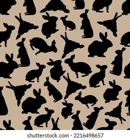 Seamless pattern with black rabbits on a beige background. For textiles and packaging. Vector illustration.