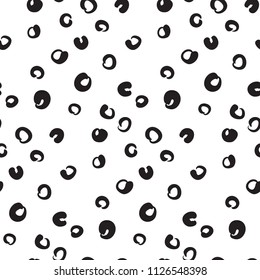 Seamless pattern with black rings, dots, circles on white background. Abstract geometric grunge hand drawn texture. Sketch drawing. Modern hipster print with doodles. Vector illustration.