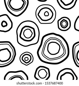 Seamless pattern with black shabby circles on white background. Kaleidoscope wallpaper. Decorative hand drawn ornament. Vector illustration. Ethnic style print