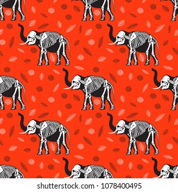 Seamless pattern. Black silhouette of an elephant with a white skeleton. The skeleton of an elephant among the leaves. Great for tattoo and printing on a T-shirt. Ideal for decoration of Halloween.