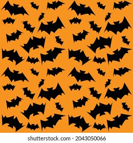 Seamless pattern with black silhouettes bats on the orange background for Halloween. Packaging design element.