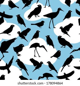 seamless pattern with black silhouettes birds on sky background 