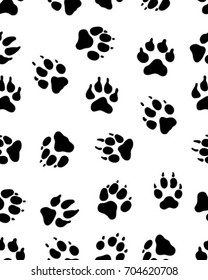 Seamless pattern of black silhouettes of prints of dog paw