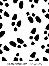 Seamless pattern of black silhouettes of prints of shoes