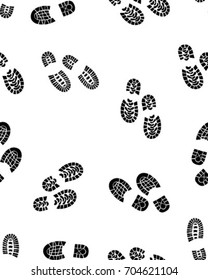 Seamless pattern of black silhouettes of prints of shoes