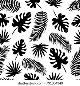 Seamless pattern with black silhouettes of tropical leaves isolated on white background. Endless texture with exotic plants