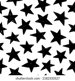 Seamless pattern with black star silhouettes. Seamless abstract pattern with black hand drawn shabby stars on white background. Cosmos texture for paper, wrapping and fabric. Geometric ornament.