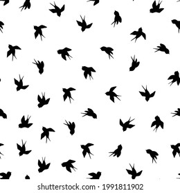 Seamless pattern with black swallow silhouette on white background. Cute bird in flight. Vector illustration.  Doodle style. Design for invitation, poster, card, fabric, textile.