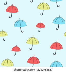 Seamless pattern with black umbrellas and leaves on a white background. Cute autumn print for textiles, wrapping paper and design