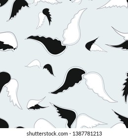 Seamless pattern black and white wings on a beige background
