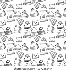 Seamless pattern with black-and-white winter hats on white background. Doodle style. Vector image.
