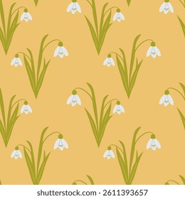 Seamless pattern with blooming snowdrop flowers and green leaves on a warm yellow background. Concept of early spring, natural elegance and seasonal floral repeat design