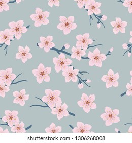 Seamless pattern with blossoming branches of cherry. A tree branch with pink flowers and buds on a blue background. Spring floral background. Vector illustration