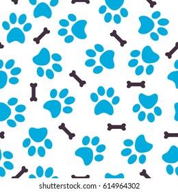 Seamless pattern of blue animal prints of paws with bones
