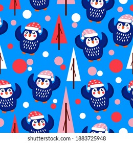 Seamless pattern blue baby penguins in pink, red and white hats and scarfs. Dancing with hands up. Blue background. Fir trees. Merry Christmas. Wallpaper, textile, scrapbooking and wrapping paper