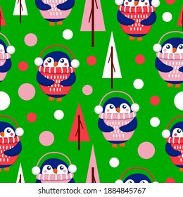 Seamless pattern with blue baby penguins wearing pink, red and white sweaters, hats and headphones. Green background. Fir trees. Merry Christmas. Wallpaper, textile, scrapbooking and wrapping paper