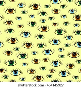 seamless pattern of blue eyes, green, brown on a yellow background