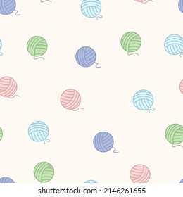 Seamless pattern of blue, green, pink, purple balls of thread. On a beige background.