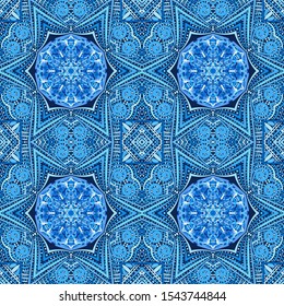 Seamless pattern. Blue snowflakes on an openwork background. Checkered structure.