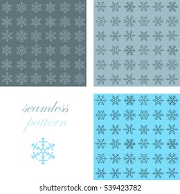 Seamless  pattern of blue  snowflakes on a dark background