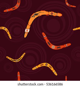 Seamless pattern with boomerangs and abstract circles on background. Australian aboriginal ornament. Aboriginal painting style. Vector background.