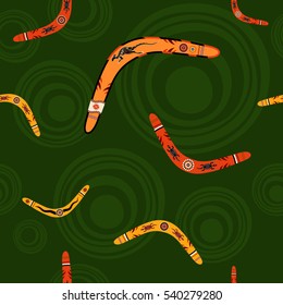 Seamless pattern with boomerangs and abstract circles on background. Australian aboriginal ornament. Aboriginal painting style. Vector background.