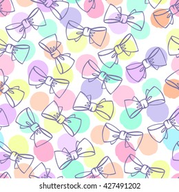 Seamless pattern with bows on a polka dot background