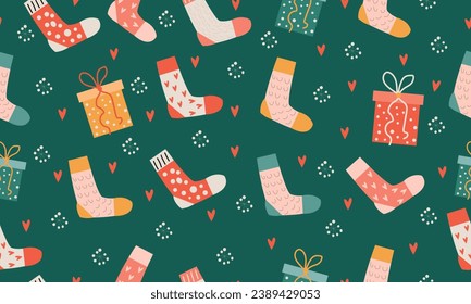 Seamless pattern with bright Christmas socks on a green background.
